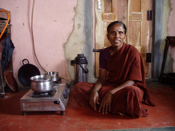 Woman cooking using biogas