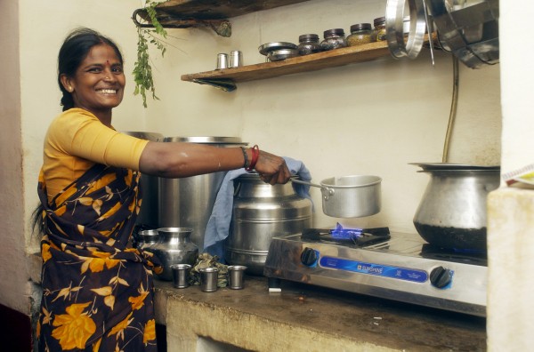 Woman cooking using biogas