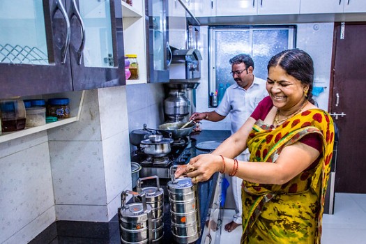 Asha Ashok Bhoite and her husband Ashok Dattatray Bhoite working together in the kitchen to prepare tiffin meals.