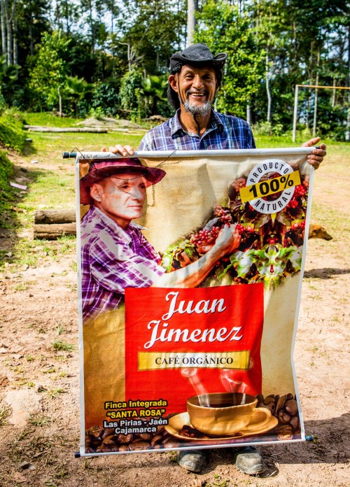 Cenfrocafe member farmer Juan Jimenez holding up a poster for his organic fair trade coffee.